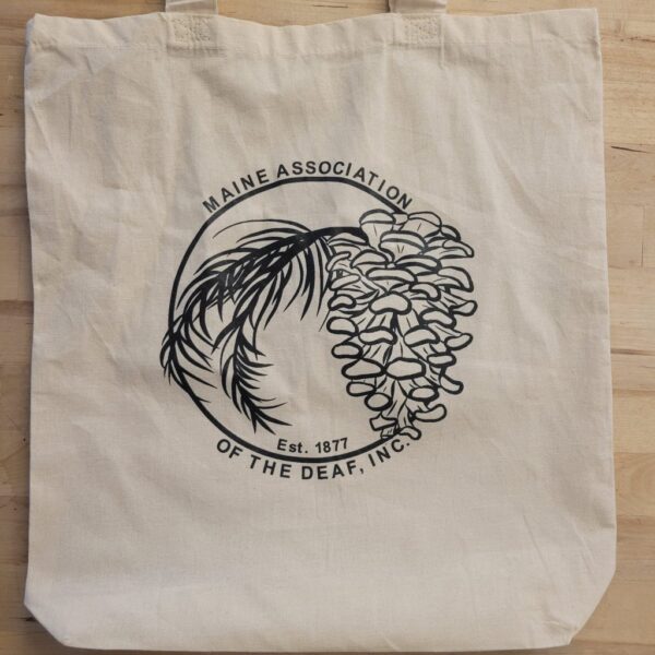 White reusable canvas bag with black MeAD Logo printed on the side.