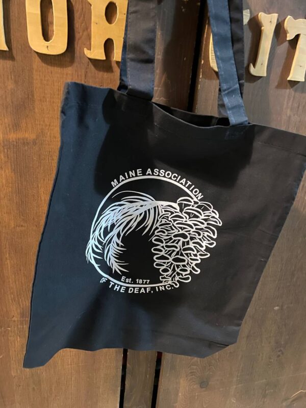 MeAD Black canvas bag with white logo printed on the side.
